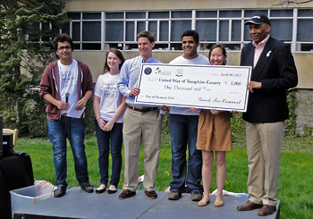 Members of Greek community present check to United Way