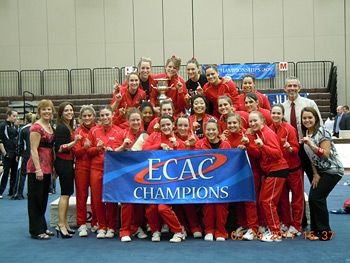 Big Red women's gymnastics team with ECAC championship banner