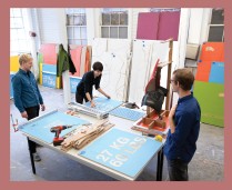 Spencer Lapp, B.Arch. '09, Sarah Haubner, M.Arch. II '10, and Ben Widger, M.Arch. '11, work on color-coded Nano exhibition panels in The Foundry.