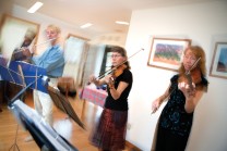Kathy Selby plays fiddle during party at home