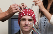 Electrophysiological cap being fitted to student in lab