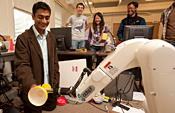 Robot hands a cup to Prof. Saxena