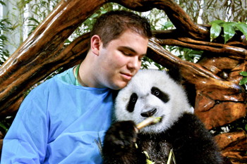 Nolan Jones with panda cub in China