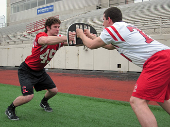 Football players use the BearClaw during a drill