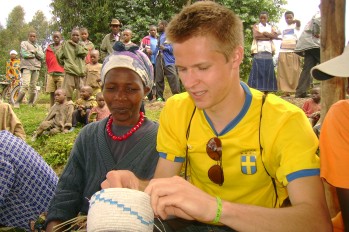 Brian Matuszewski '11 learns how to weave a basket at a womens cooperative in Ibyiwacu cultural village, Rwanda