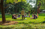Students discuss The Grapes of Wrath outdoors with government professor Matthew Evangelista