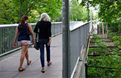 People walk across the footbridge 