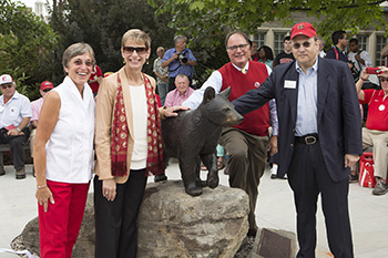 Susan Murphy, Cornell President Elizabeth Garrett, Joseph Thanhauser and others pose with the new Touchdown statue during its dedication in September.