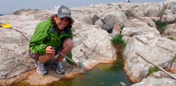 Kara Pellowe '12 takes a water sample from an intertidal rock pool on Appledore Island
