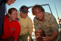 Willy Bemis '76, right, director of Shoals Marine Laboratory, holds a sea raven