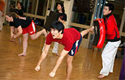 members of the Cornell Taekwondo team practice in Helen Newman Hall