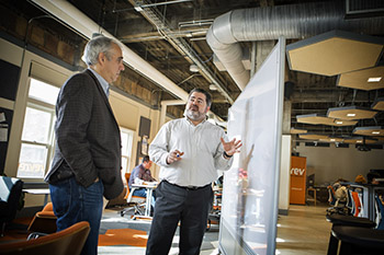 Ken Rother, left, Rev's director of hardware entrepreneurship, and Tom Schryver, MBA '02, executive director of Cornell's Center for Regional Economic Advancement, at Rev: Ithaca Startup Works in downtown Ithaca.