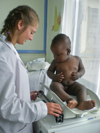 Weighing a baby in Kenya.