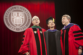 David Skorton, Elizabeth Garrett and Robert Harrison lead the alma mater following Charter Day ceremonies