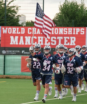 Ryan McClay '03 carries the U.S. flag onto the field at lacrosse world championships