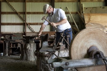 Harbert at work with hammer and anvil