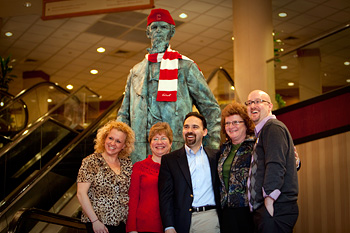 Alumni pose with Ezra Cornell statue at Washington, D.C. hotel